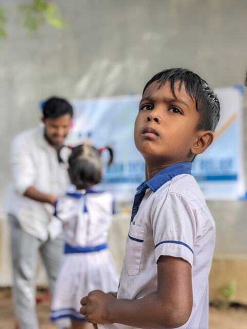 Portrait of a schoolboy at an NHDR distribution event